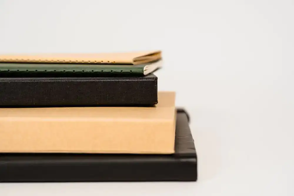 Stack of premium textured paper notebooks
