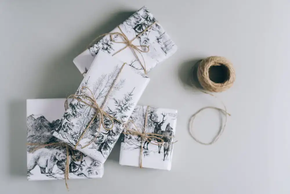 A stack of carefully wrapped gift boxes tied with fine twine