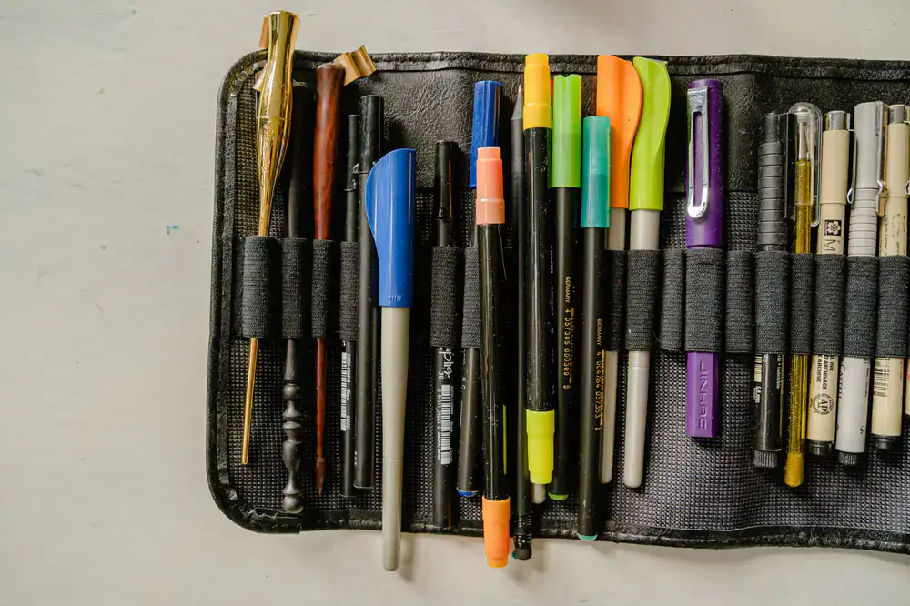 Fountain pens and fine liners resting on paper